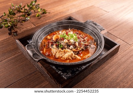 Spicy beer beef offal pot served dish isolated on wooden table top view of Hong Kong food