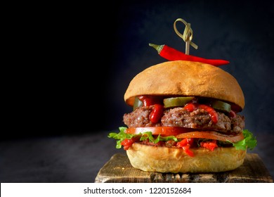 Spicy Burger With Chili On Dark Background