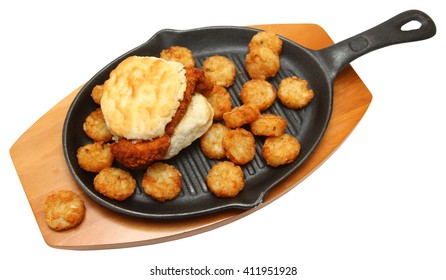 Spicy Chicken Biscuit And Hashbrowns On Skillet Isolated Over White