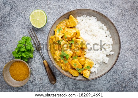 Spicy chicken cooked with curry sauce and rice, top view