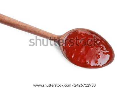 Spicy chili sauce in spoon isolated on white, top view