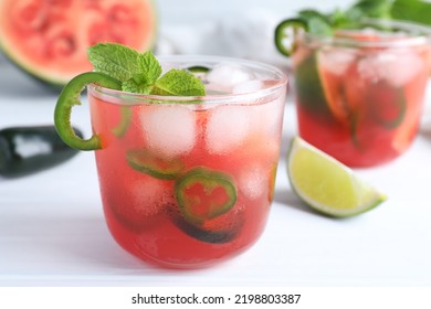 Spicy Cocktail With Jalapeno And Mint On White Table, Closeup