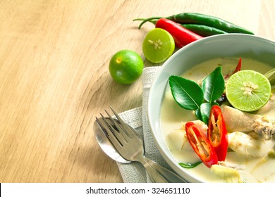 Spicy Creamy Coconut Soup With Chicken , Thai Food Called Tom Kha Gai On Wooden Table