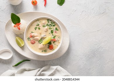 Spicy Creamy Coconut Tom Kha Gai Soup With Chicken, Cherry Tomato, Coconut Milk, Kaffir, Galangal, Lemongrass,mushrooms. Asian Thai Food. Coconut Chicken Soup. View From Above. Copy Space.