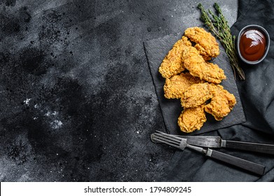 Spicy Deep Fried Breaded Chicken Wings. Black Background. Top View. Copy Space