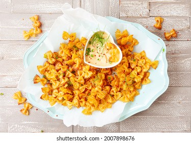 Spicy farfalle pasta chips with homemade herb dip