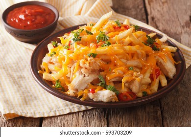 Spicy Fast Food: French Fries With Cheddar Cheese, Chili And Chicken Fillet Close-up On A Plate. Horizontal
