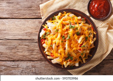 Spicy Fast Food: French Fries With Cheddar Cheese, Chili And Chicken Fillet Close-up On A Plate. Horizontal View From Above
