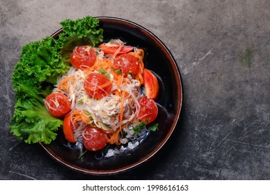 Spicy Glass Noodle Salad With Salted Egg Yolk In A Black Plate