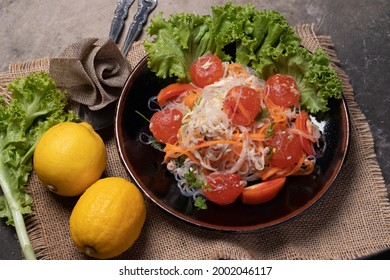 Spicy Glass Noodle Salad With Salted Egg Yolk In A Black Plate