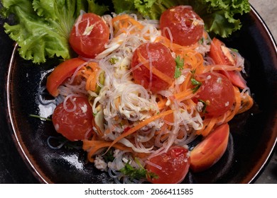 Spicy Glass Noodle Salad With Salted Egg Yolk In A Black Plate