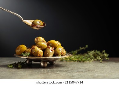 Spicy green olives are poured with olive oil with spices. Copy space. - Powered by Shutterstock