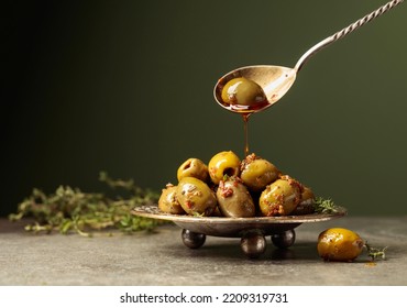 Spicy green olives are poured with olive oil with spices. Copy space. - Powered by Shutterstock