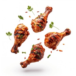 Spicy Grilled Chicken Legs Or Drumsticks Flying With Herbs And Spices. Floating BBQ Chicken Drumsticks With Vegetables Isolated On White Background.