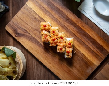 Spicy Halibut Ura Maki On Wooden Plate