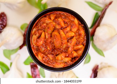 Spicy Indian homemade garlic pickle on a color background selective focus 