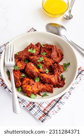 Spicy Indian Stir-Fried Chicken in a Bowl Top Down Photo on White Background Vertical Photo - Shutterstock ID 2311284371