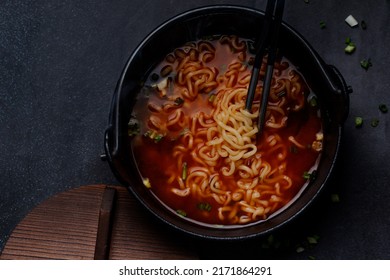 Spicy Korean Instant Noodles With Wakame Seaweed In A Black Iron Pot, Korean Food Traditional Style