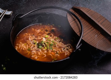 Spicy Korean Instant Noodles With Wakame Seaweed In A Black Iron Pot, Korean Food Traditional Style