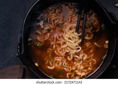 Spicy Korean Instant Noodles With Wakame Seaweed In A Black Iron Pot, Korean Food Traditional Style