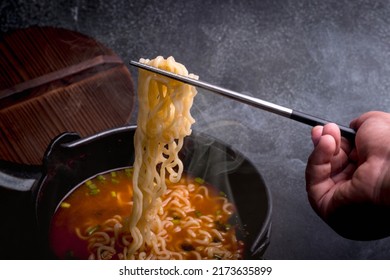 Spicy Korean Instant Noodles With Wakame Seaweed In A Black Iron Pot, Korean Food Traditional Style