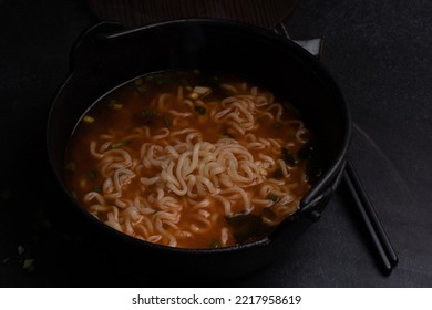 Spicy Korean Instant Noodles With Wakame Seaweed In A Black Iron Pot, Korean Food Traditional Style