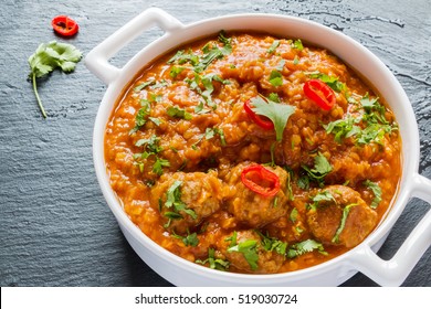 Spicy Lentil And Meatball Soup With Parsley. White Casserole On Black Stone Background.