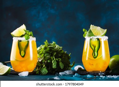 Spicy Margarita Cocktail With Tequila, Mango Juice, Jalapeno Pepper, Lime And Salt, Blue Background, Copy Space