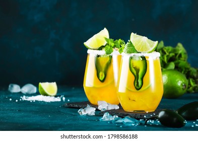 Spicy Margarita Cocktail With Tequila, Mango Juice, Jalapeno Pepper, Lime And Salt, Blue Background, Copy Space