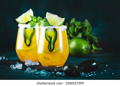 Spicy Margarita Cocktail With Tequila, Mango Juice, Jalapeno Pepper, Lime And Salt, Blue Background, Copy Space