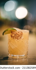 Spicy Margarita With A Tajin Rim Sitting On The Bar Top.