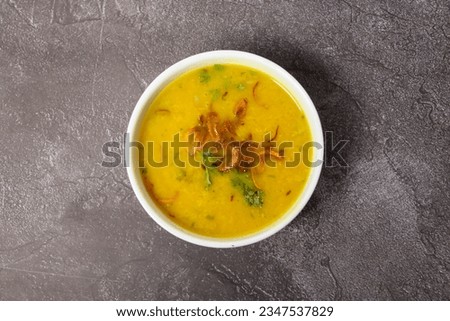 Spicy masoor dal or ghono dal with fried onion served in dish isolated on background top view of bangladesh food