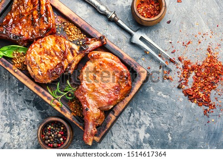 Spicy meat grilled spare ribs on wooden cutting board.Roasted ribs