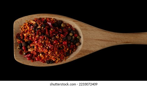 Spicy mixture of spices with chopped lemon peel, chili, peppercorns (black, green and red), mustard seeds, allspice, chopped ginger in wooden spoon isolated on black, top view - Shutterstock ID 2233072409