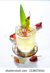 Spicy Pineapple Margarita On Ice In Rocks Glass Against White Background