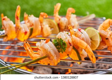 Spicy Prawn Tails Grilling On Skewers Over A Hot Barbecue Outdoors In A Park Or Garden In Spring For Healthy Outdoor Living