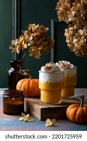 Spicy pumpkin latte with whipped cream. Autumn or winter hot coffee drink with cinnamon, nutmeg 