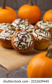 Spicy Pumpkin Muffins Decorated Ghosts, Spiderweb For Halloween Celebration. Autumn Composition With Pumpkins, Cupcakes On Dark Stone Table. Fall Time. Selective Focus. Vertical Orientation.