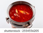 Spicy red oil pot bottom with a small Hot pot on a white background