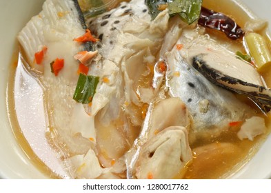 Spicy Salmon Fish Head And Straw Mushroom In Tom Yum Soup On Bowl