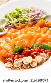 Spicy salmon  salad as a traditional Thai spicy salad, street food, close up