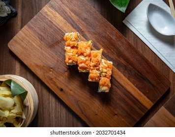 Spicy Salmon Ura Maki On Wooden Plate