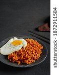 Spicy Samyang Noodle with sunny side up egg. Selective focus. Rough background. 