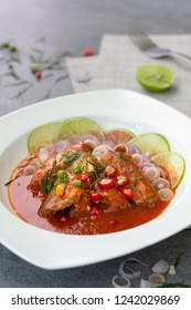 Spicy Sardine Salad With Tomato Sauce In White Dish On Concrete Table.