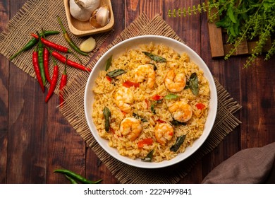 Spicy Shrimp Fried Rice with thai holy basil leaves in white plate.Top view