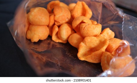 Spicy Snack With Red Chili Balado. Crackers With Red Spicy Powder