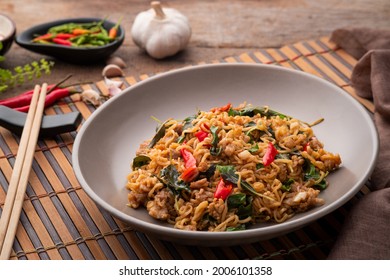 Spicy stir fried instant noodle with minced pork and thai basil leaves