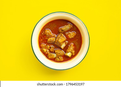 Spicy Stir Fried Pork Sparerib With Thai Southern Chili Paste In Zinc Bowl On Yellow Background.