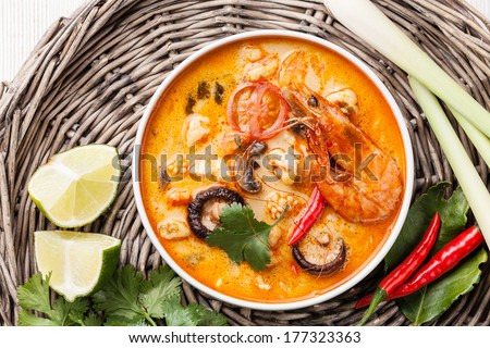 Spicy Thai soup Tom Yam with Coconut milk, Chili pepper and Seafood