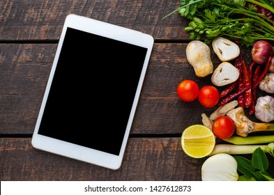 Spicy Tom Yum With Ingredients On The Wooden Floor Table Background Asian Food Cooking Concept,top View,tablet.